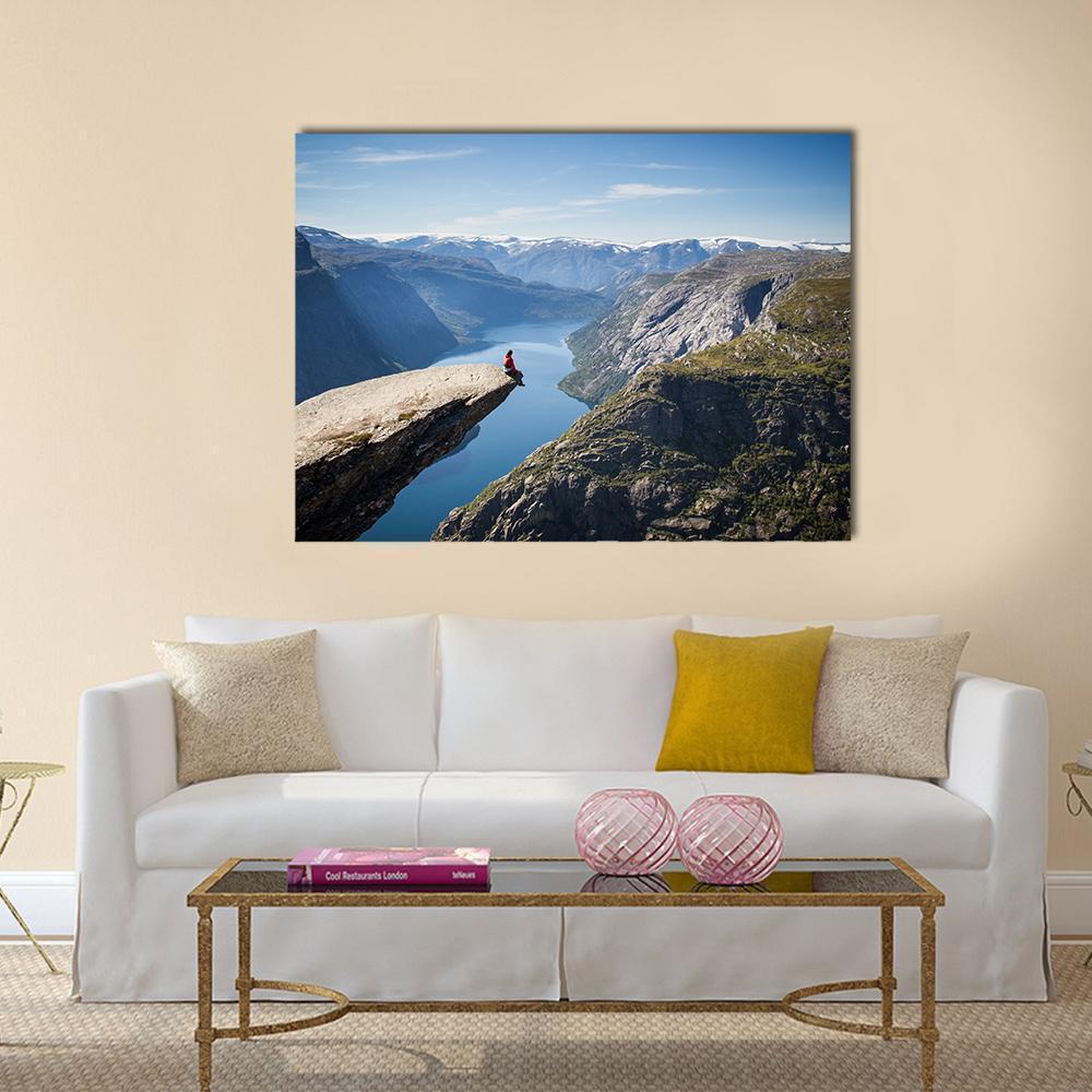 Person on Trolltunga During Daytime Canvas Wall Art in gray, brown and blue, single panel hung on a wall