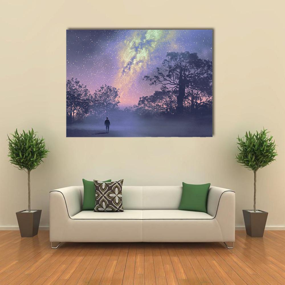 Man Silhouette Under Vibrant Milky Way Canvas Wall Art in yellow, blue and purple, single panel hung on a wall