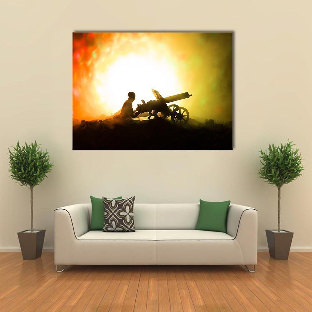 Soldier Silhouette Operating Cannon at Sunset Canvas Wall Art in black, orange and yellow, single panel hung on a wall