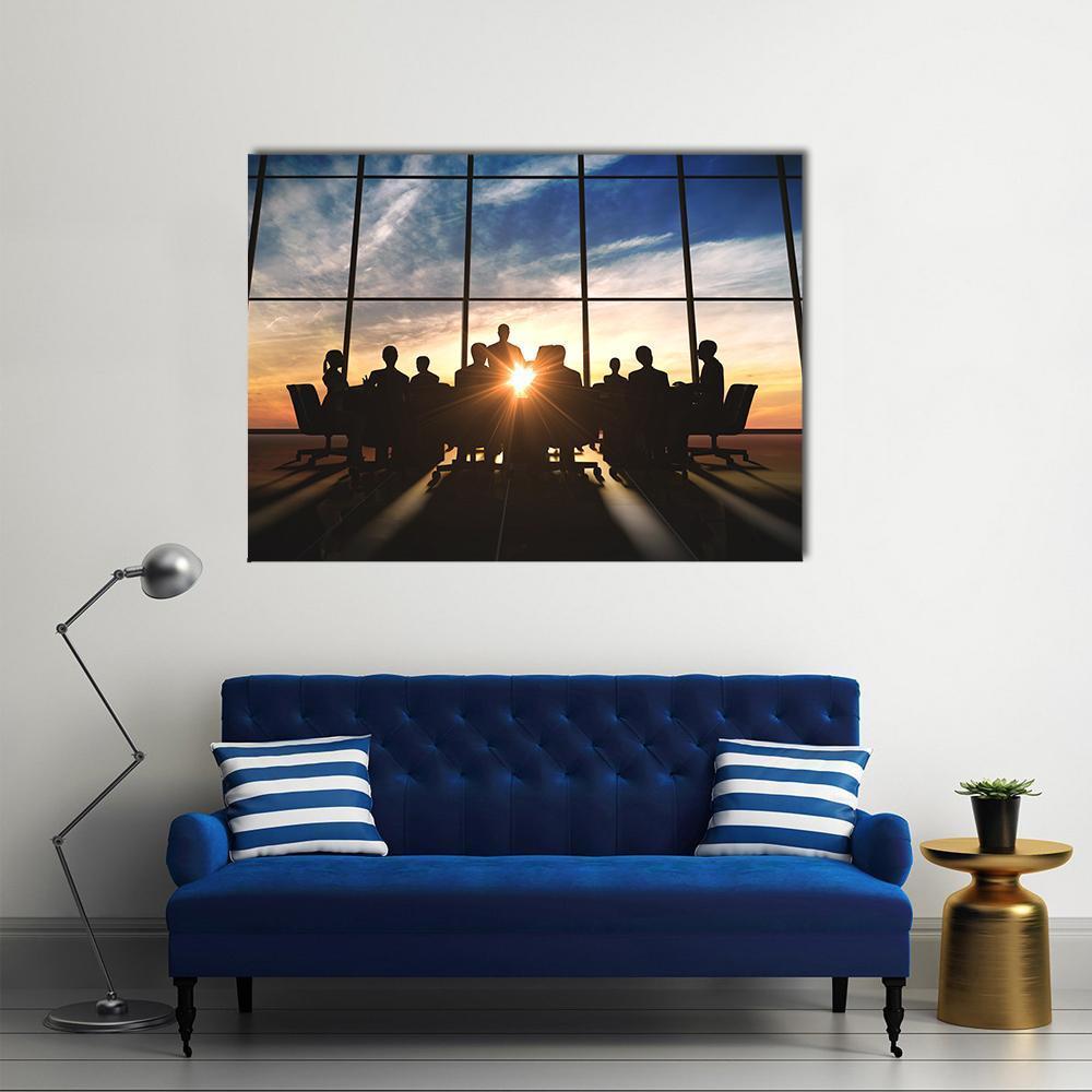 Management Team Silhouette at Sunset Canvas Wall Art in black, orange and blue, single panel hung on a wall