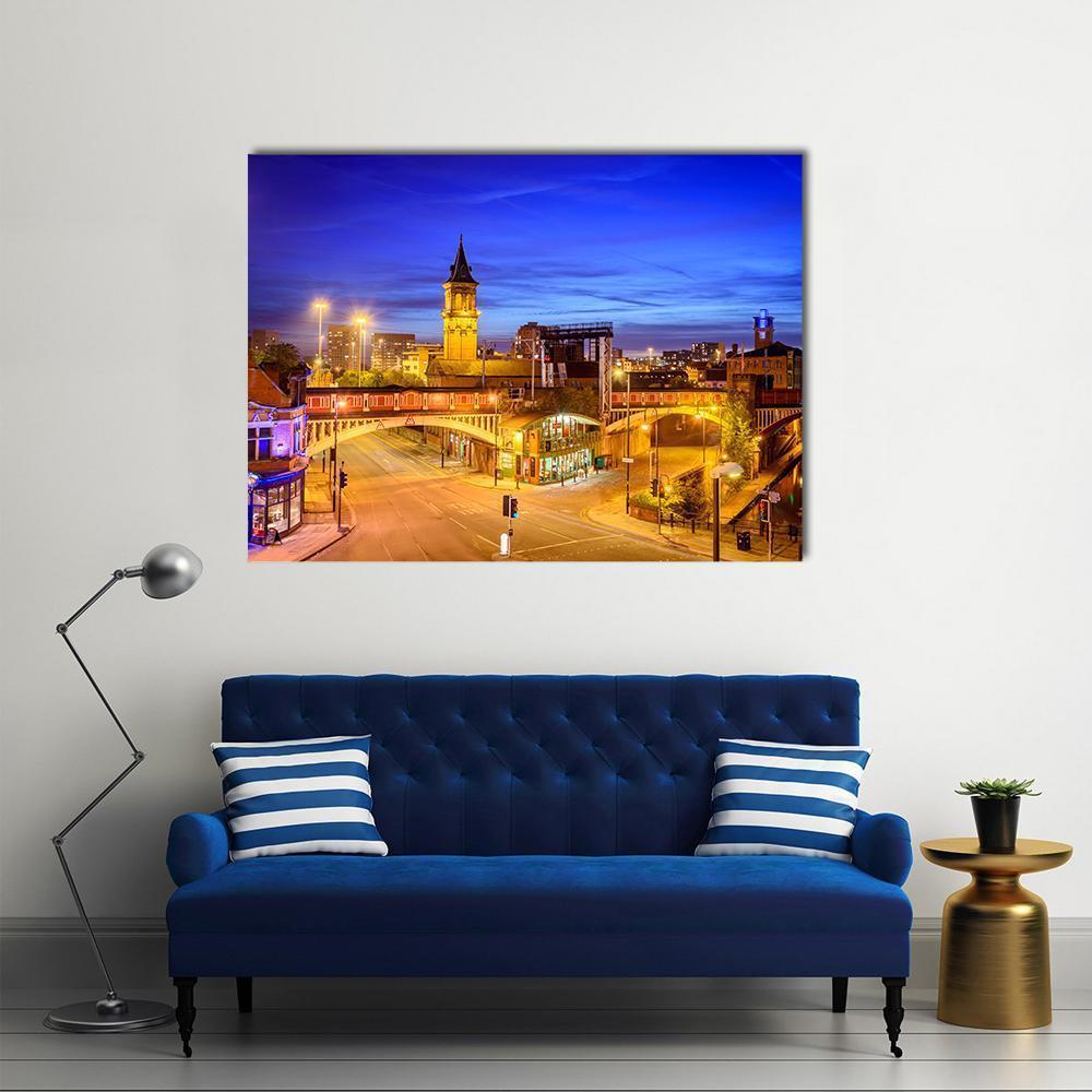 Manchester Night Cityscape with Clock Tower Spire Canvas Wall Art in orange, yellow and blue, single panel hung on a wall