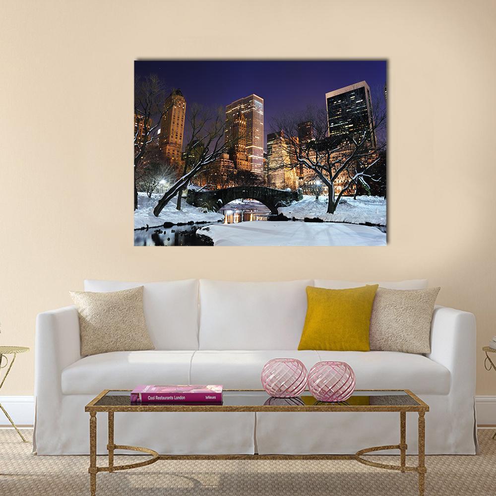 Snowy Central Park Bridge in Winter Canvas Wall Art in black, white and blue, single panel hung on a wall