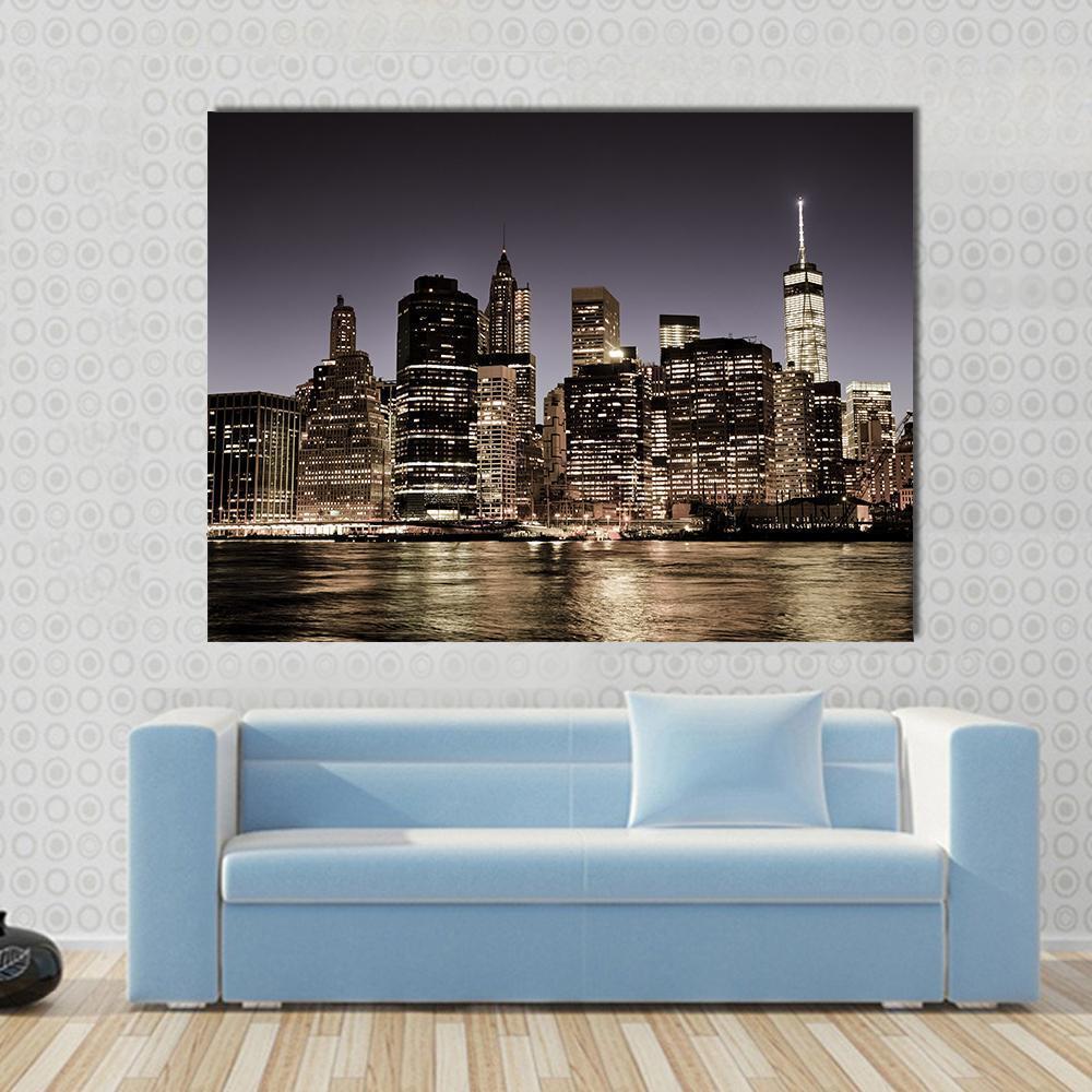 Manhattan Skyline at Night Canvas Wall Art in black, gray and gold, single panel hung on a wall