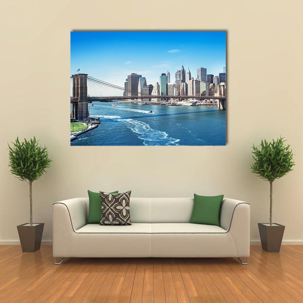 Manhattan Skyline with Brooklyn Bridge Canvas Wall Art in gray and blue, single panel hung on a wall