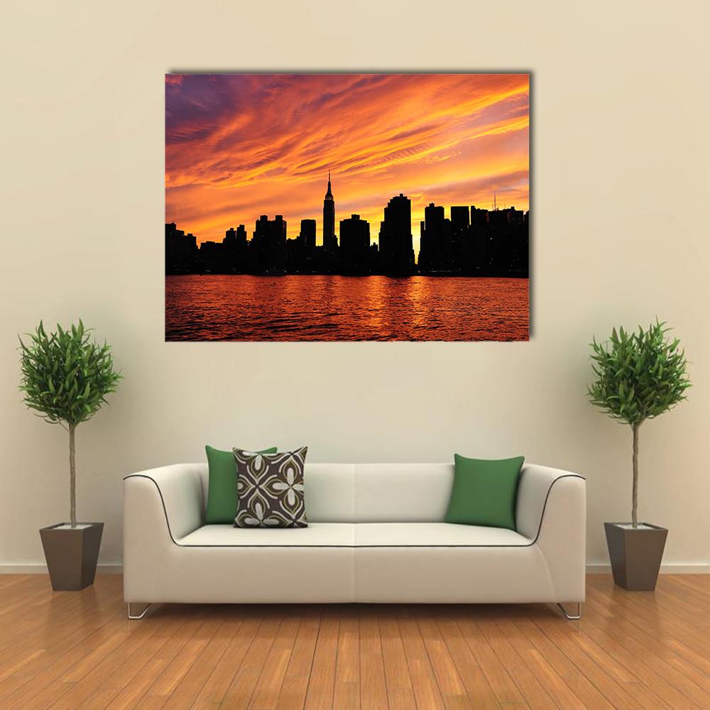 Manhattan Midtown Silhouette Canvas Wall Art in black, orange and yellow, single panel hung on a wall