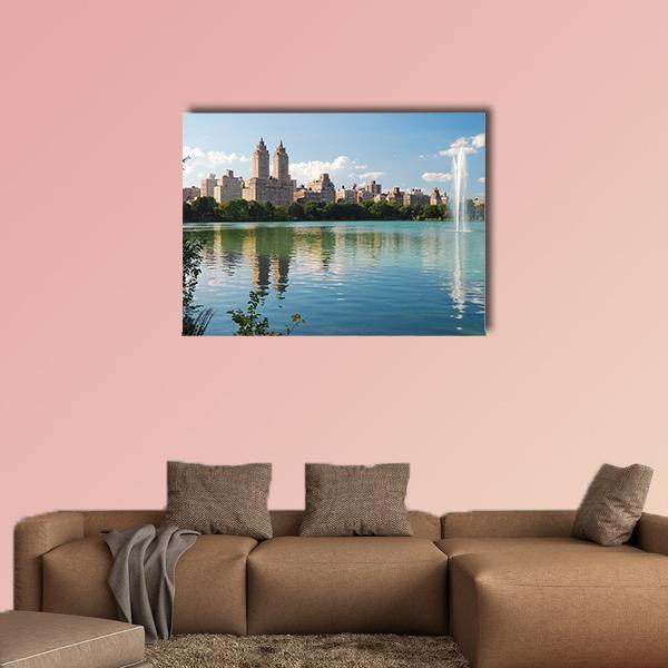 Manhattan Skyline with Fountain Canvas Wall Art in beige, green and blue, single panel hung on a wall
