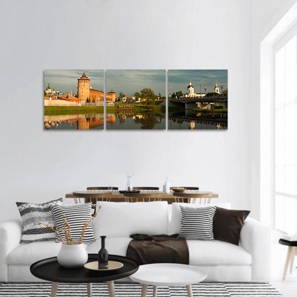 Marinkin Tower with Church by River Panoramic Canvas Wall Art in brown, green and blue, hung on a wall