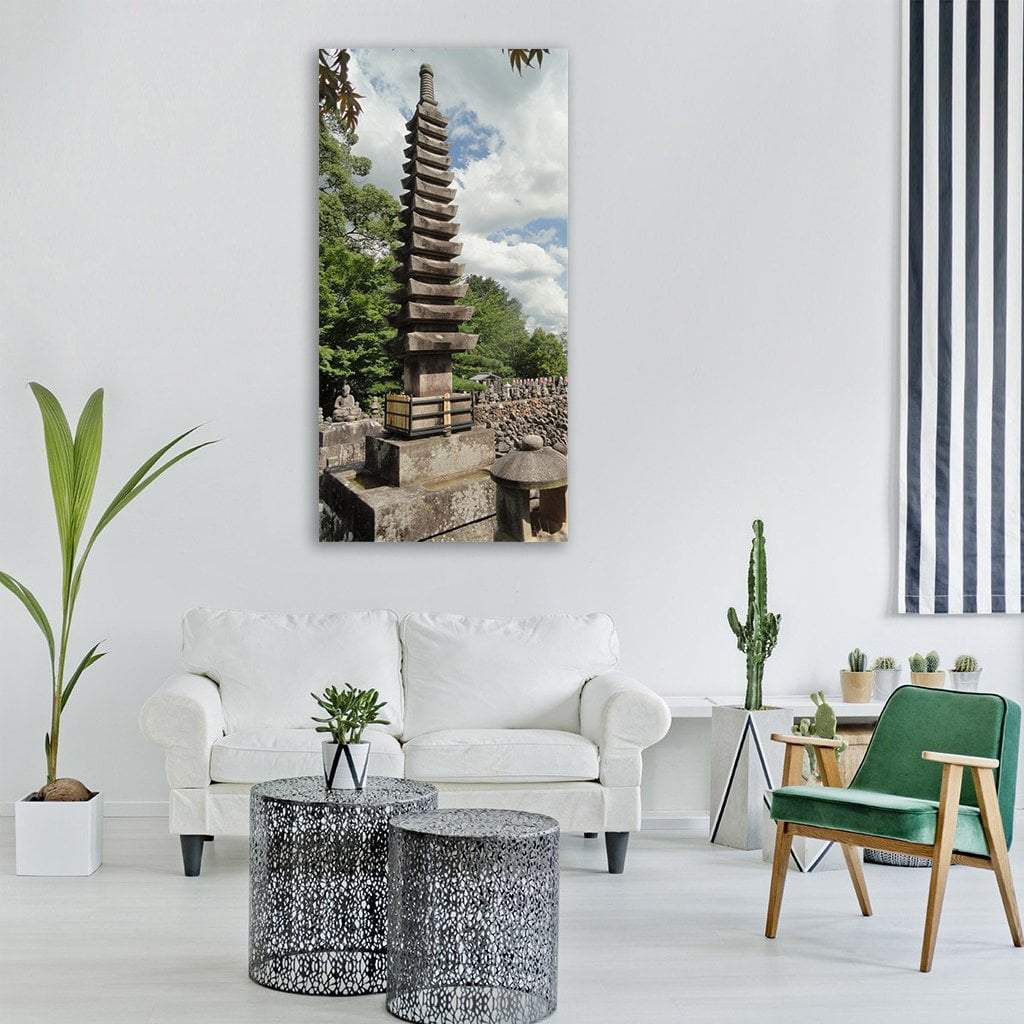 Japanese Stone Pagoda in Garden Vertical Canvas Wall Art in gray, green and blue, single vertical panel hung on a wall