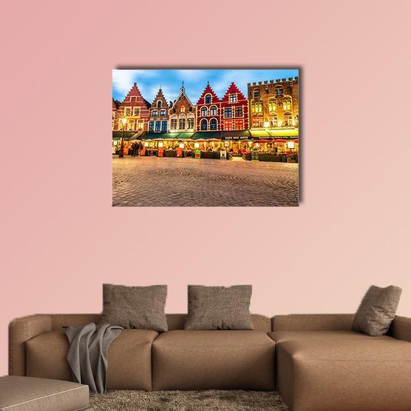 Bruges Market Square at Dusk Canvas Wall Art in brown, orange and blue, single panel hung on a wall