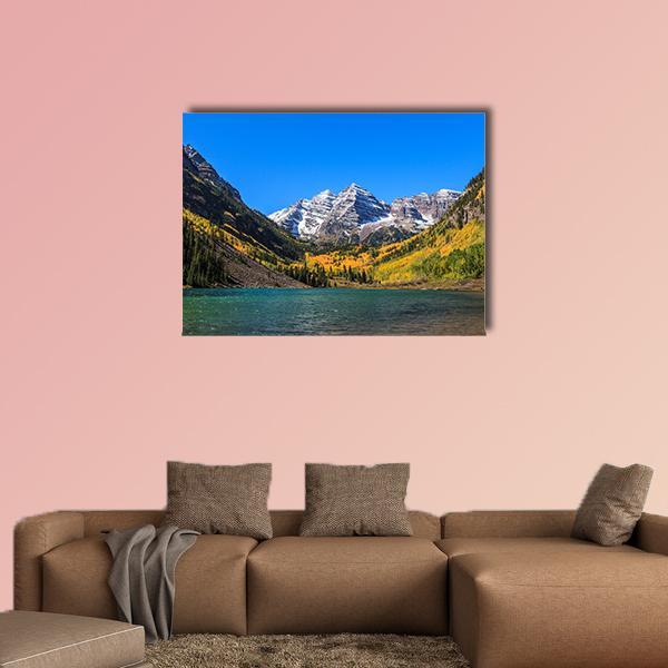 Maroon Bells Autumn Lake Canvas Wall Art in brown, yellow and blue, single panel hung on a wall