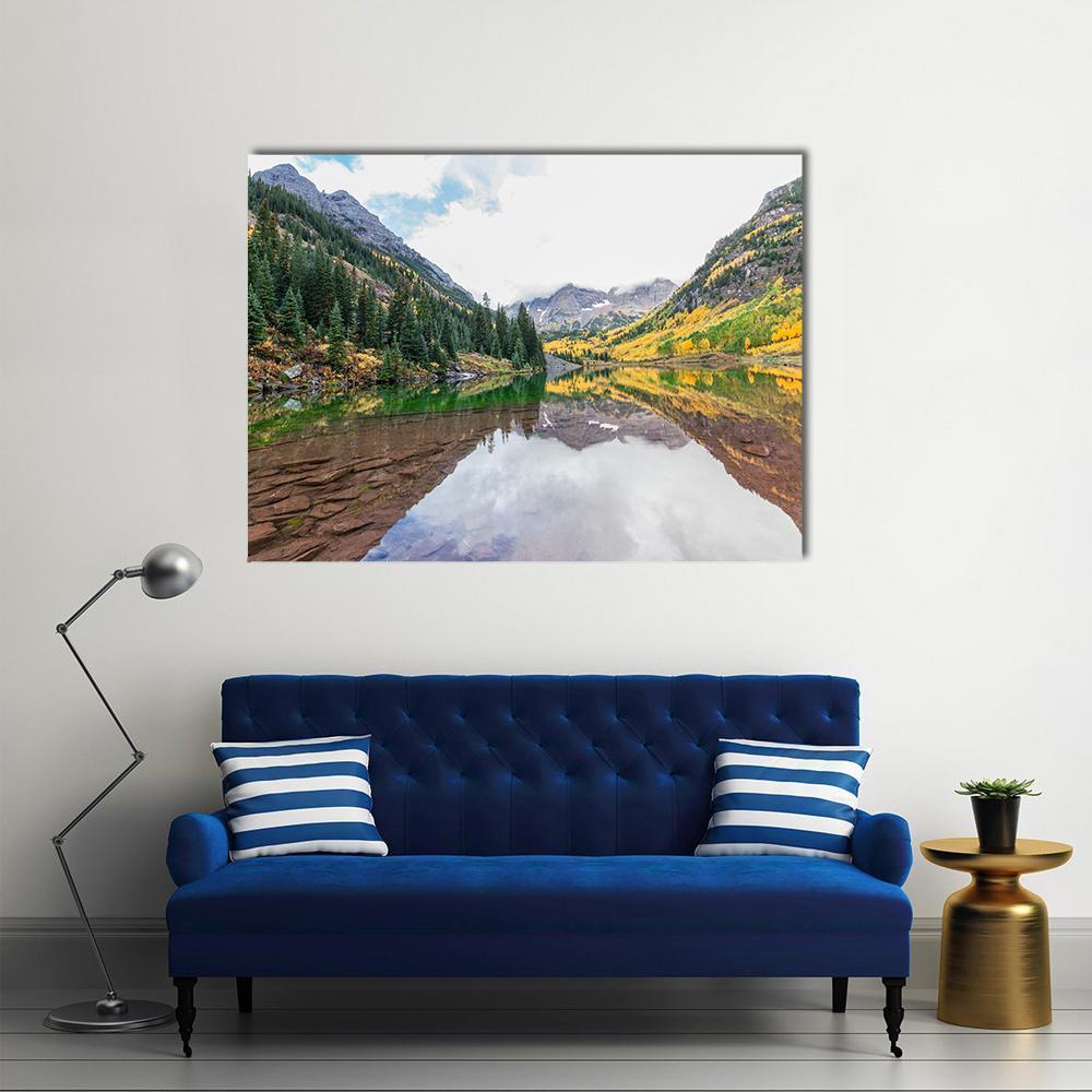 Maroon Bells in Autumn Reflection Canvas Wall Art in brown, yellow and green, single panel hung on a wall