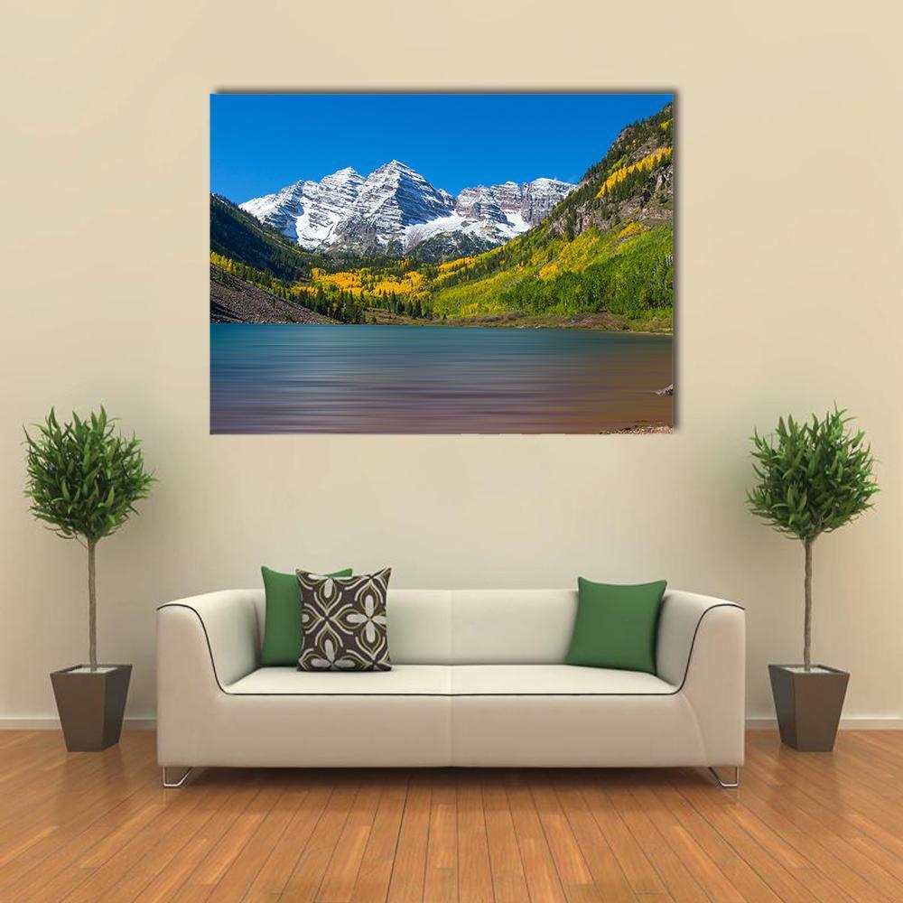 Maroon Bells in Autumn Canvas Wall Art in yellow, green and blue, single panel hung on a wall