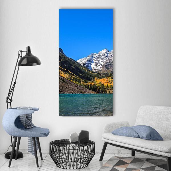 Maroon Bells Autumn Lake Reflection Vertical Canvas Wall Art in brown, yellow and blue, single vertical panel hung on a wall
