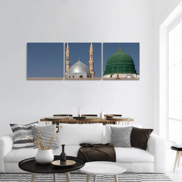 Green Dome and Minarets of Al-masjid An-nabawi Panoramic Canvas Wall Art in gray, green and blue, hung on a wall
