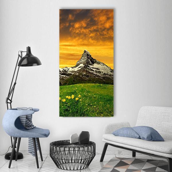 Matterhorn at Sunset Vertical Canvas Wall Art in orange, yellow and green, single vertical panel hung on a wall