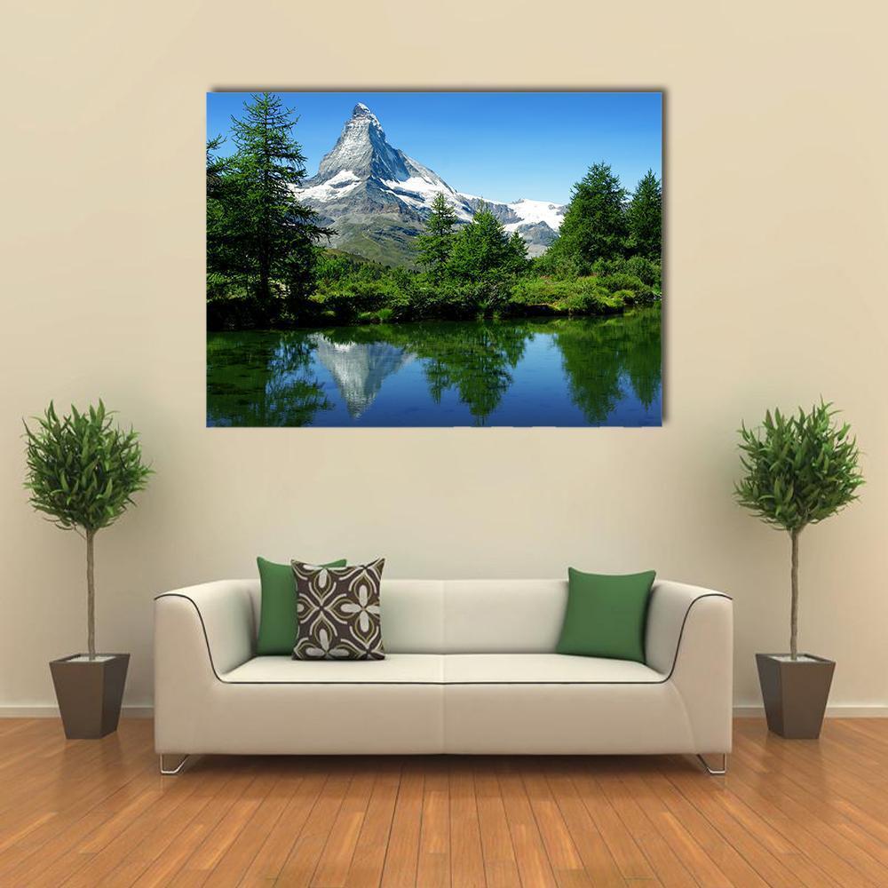 Matterhorn and Alpine Lake Reflection Canvas Wall Art in white, green and blue, single panel hung on a wall
