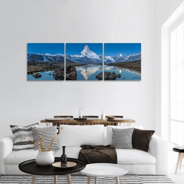 Stellilake Afternoon Matterhorn Reflection Panoramic Canvas Wall Art in white, gray and blue, hung on a wall