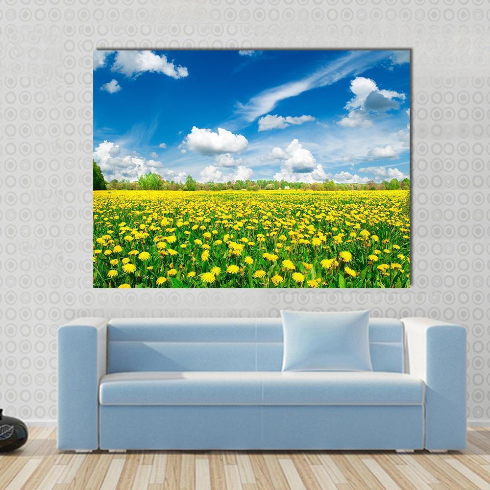 Meadow with Yellow Dandelions Canvas Wall Art in yellow, green and blue, single panel hung on a wall