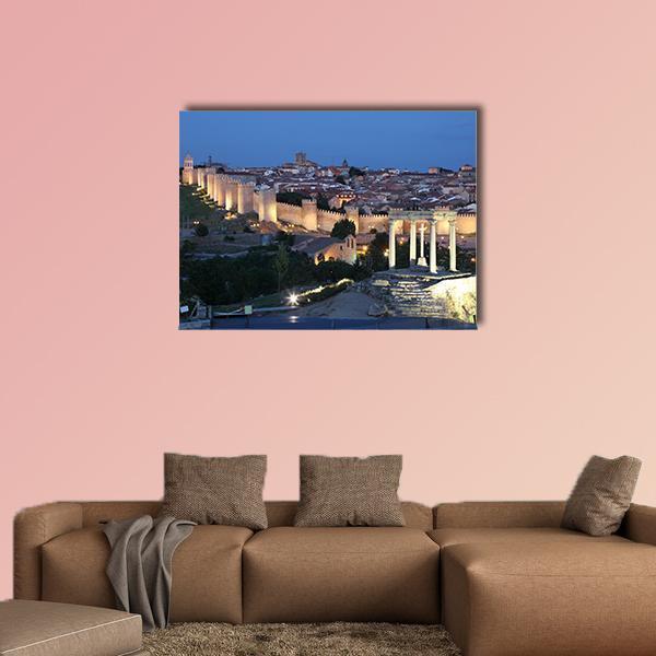 Avila City Walls at Night Canvas Wall Art in brown, yellow and blue, single panel hung on a wall