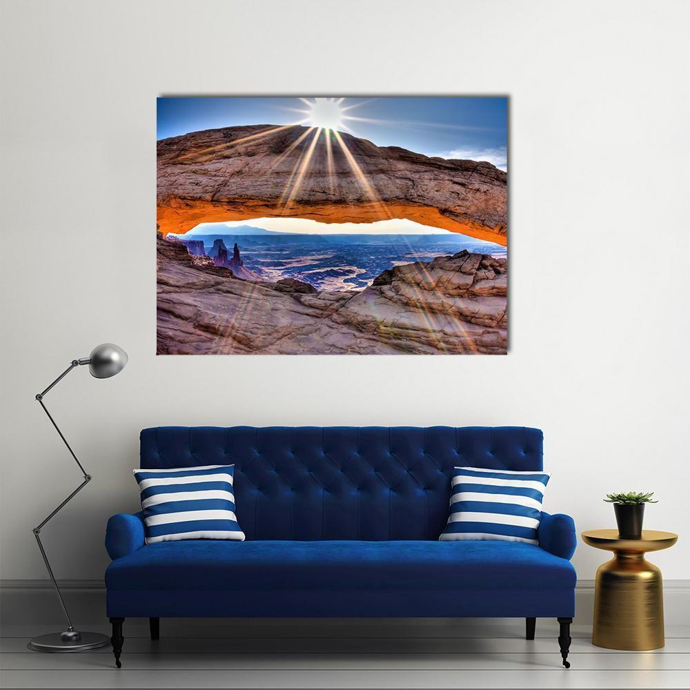 Mesa Arch at Sunrise Canvas Wall Art in brown, orange and blue, single panel hung on a wall