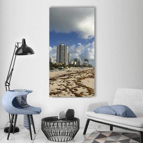 Miami Beach Shoreline with City Skyline Vertical Canvas Wall Art in gray, beige and blue, single vertical panel hung on a wall