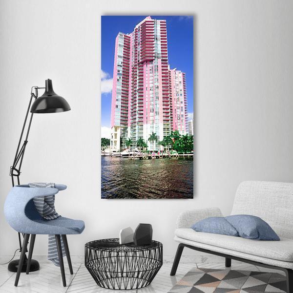 Miami Beach Skyscrapers with Palm Trees Vertical Canvas Wall Art in white, blue and pink, single vertical panel hung on a wall