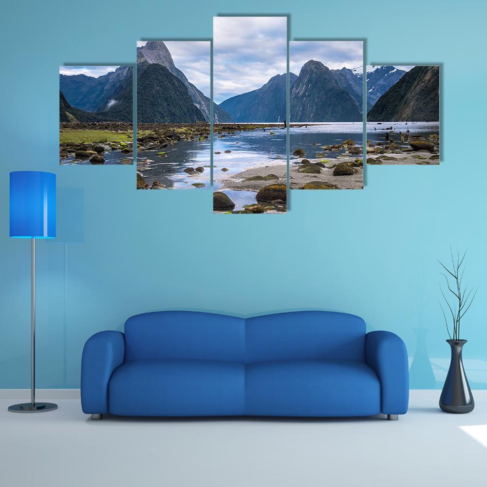 Milford Sound Calm Water and Peaked Mountains Canvas Wall Art in gray, green and blue, 5 panel Star layout hung on a wall