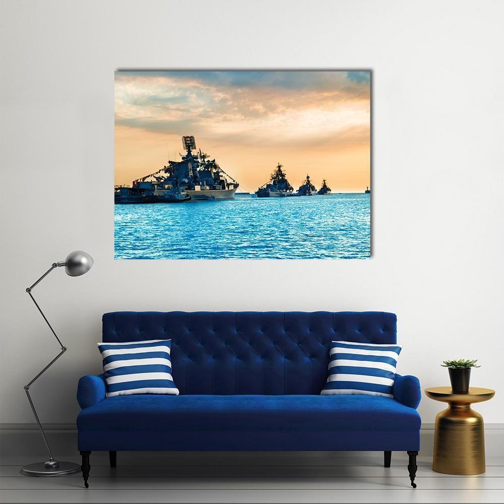 Naval Warships at Sunset Canvas Wall Art in orange, yellow and blue, single panel hung on a wall