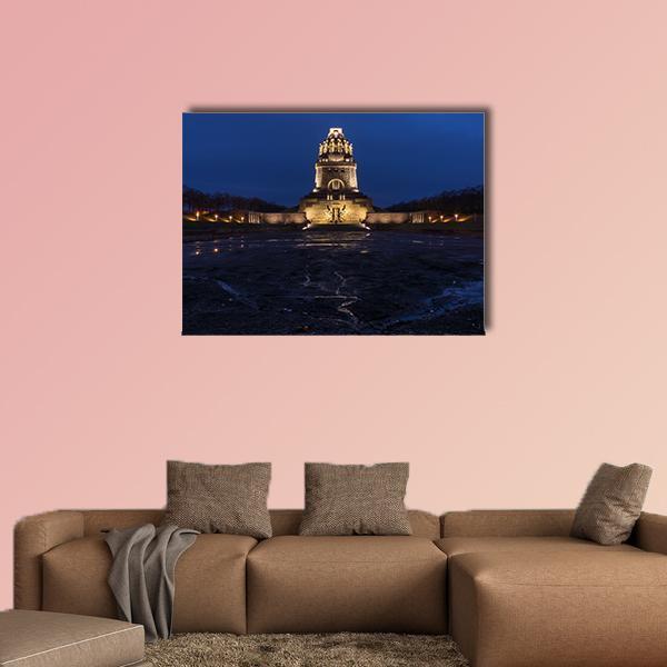 Illuminated Battle Tower at Twilight Canvas Wall Art in black, gold and blue, single panel hung on a wall