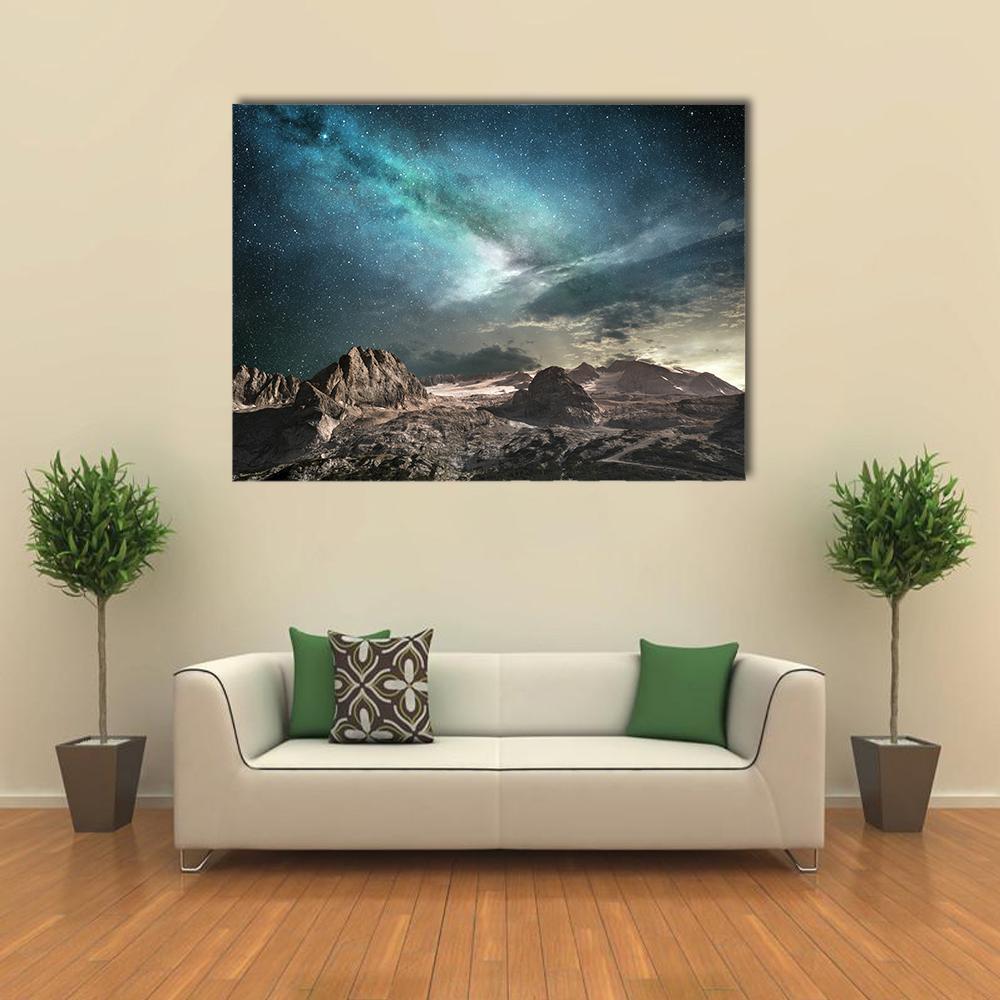 Milky Way Over Jagged Mountain Peaks Canvas Wall Art in black, gray and blue, single panel hung on a wall
