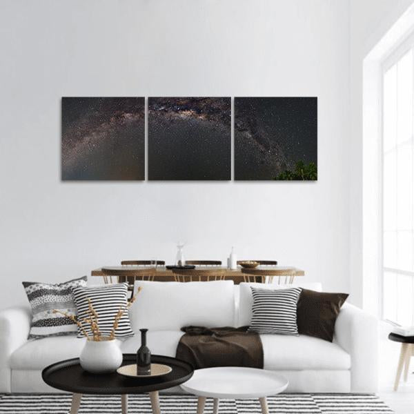 Milky Way Night Sky Panoramic Canvas Wall Art in black, gray and brown, hung on a wall