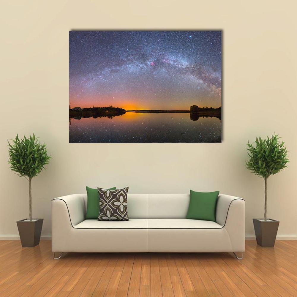 Milky Way Over Lake Canvas Wall Art in black, orange and blue, single panel hung on a wall