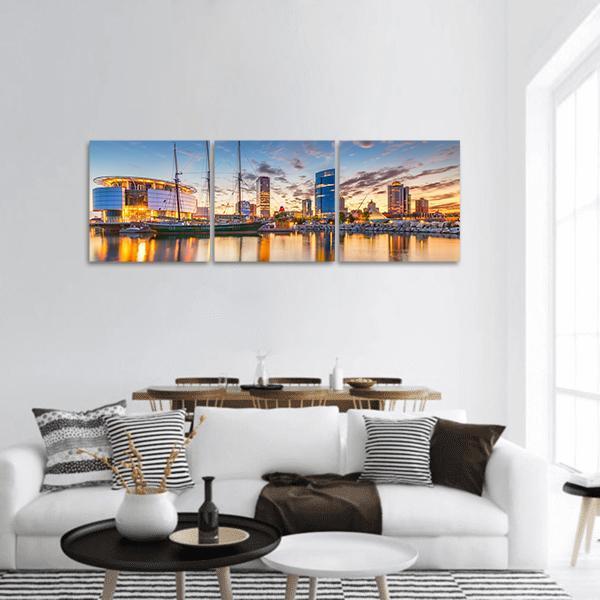 Milwaukee Harbor Skyline at Golden Hour Panoramic Canvas Wall Art in gold, orange and blue, hung on a wall