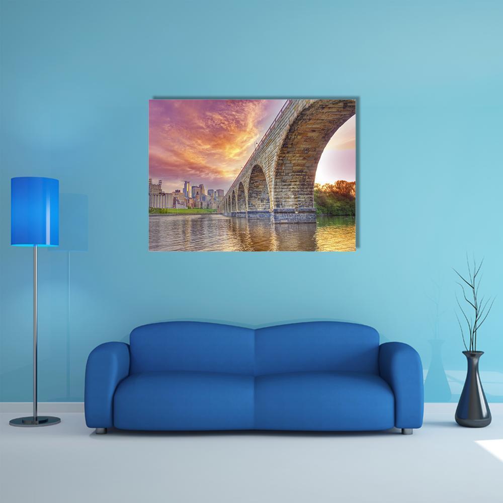 Minneapolis Arch Bridge at Sunset Canvas Wall Art in brown, orange and purple, single panel hung on a wall