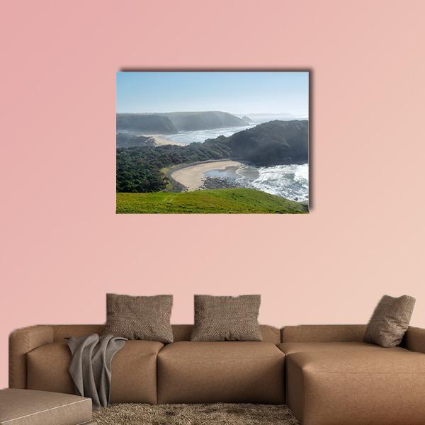 Misty Beach with Sandy Cove Canvas Wall Art in beige, green and blue, single panel hung on a wall