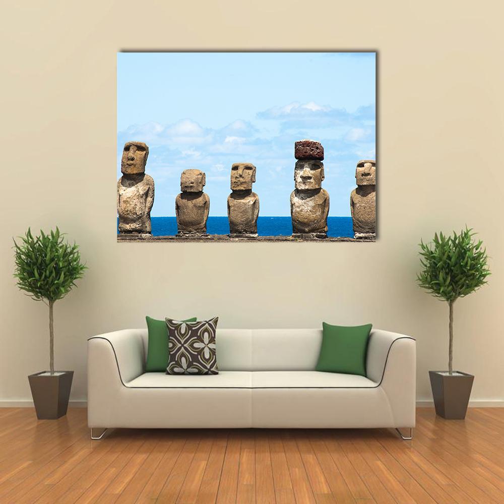 Moai Statues at Ahu Tongariki Canvas Wall Art in gray, brown and blue, single panel hung on a wall