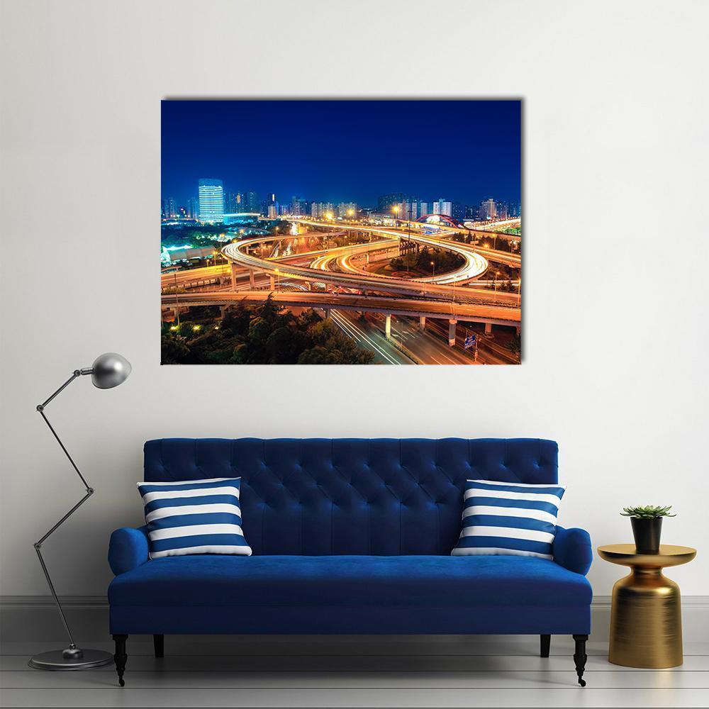 Urban Highways at Night Canvas Wall Art in orange, yellow and blue, single panel hung on a wall