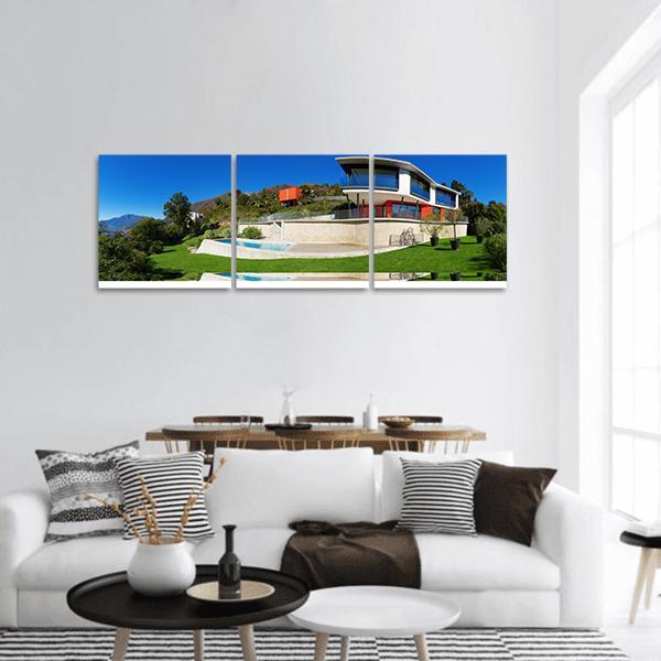 Modern Luxury Home with Pool Panoramic Canvas Wall Art in white, green and blue, hung on a wall