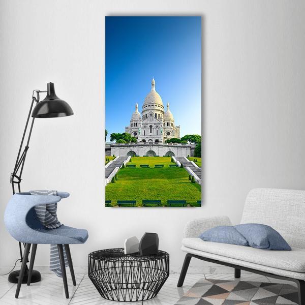 Sacré-cœur at Sunrise, Montmartre Vertical Canvas Wall Art in white, green and blue, single vertical panel hung on a wall