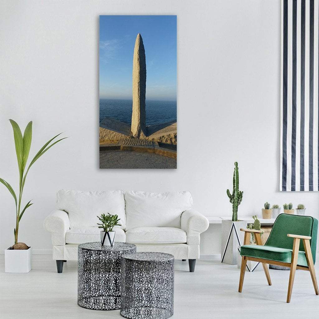 Normandy War Monument Vertical Canvas Wall Art in gray, beige and blue, single vertical panel hung on a wall