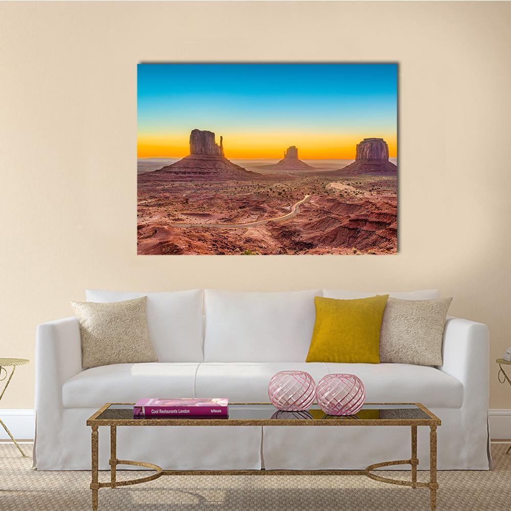 Monument Valley at Dawn Canvas Wall Art in brown, orange and blue, single panel hung on a wall