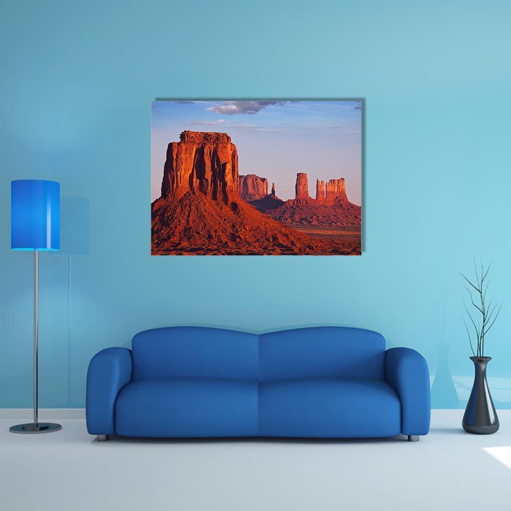 Monument Valley Sunset Canvas Wall Art in red, orange and blue, single panel hung on a wall