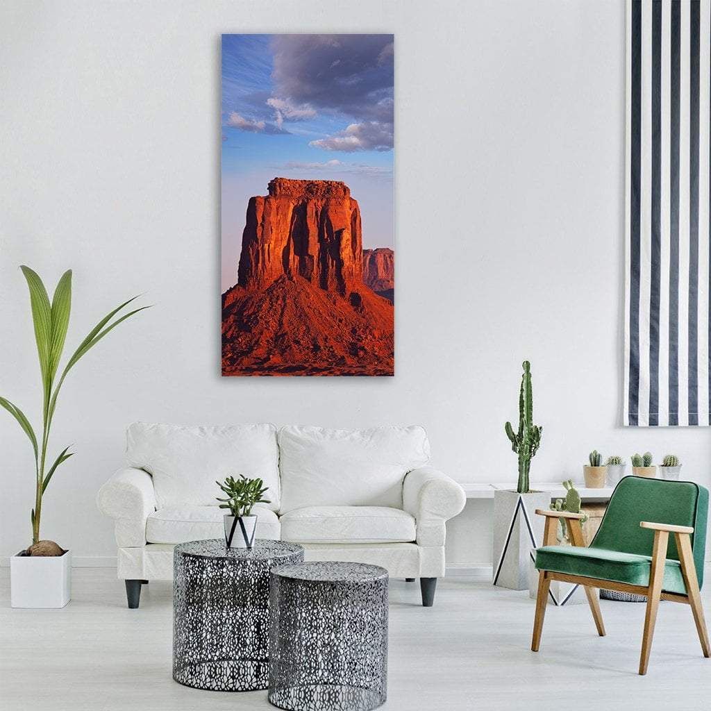 Monument Valley Red Butte at Golden Hour Vertical Canvas Wall Art in red, orange and blue, single vertical panel hung on a wall