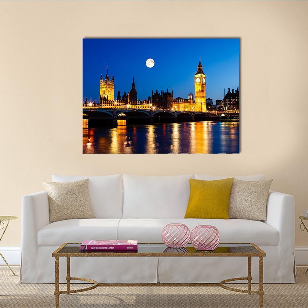 Moon Above Big Ben at Night Canvas Wall Art in gold, yellow and blue, single panel hung on a wall