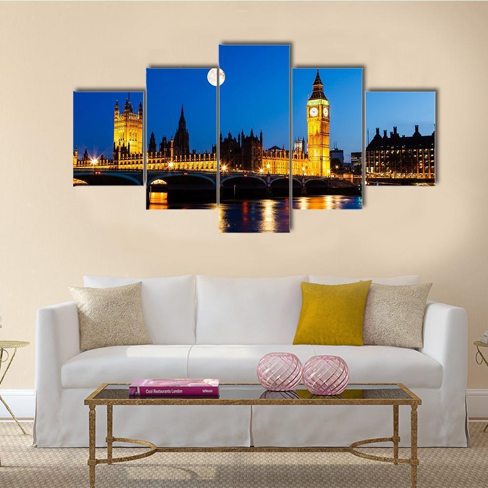 Moon Above Big Ben at Night Canvas Wall Art in gold, yellow and blue, 5 panel Star layout hung on a wall