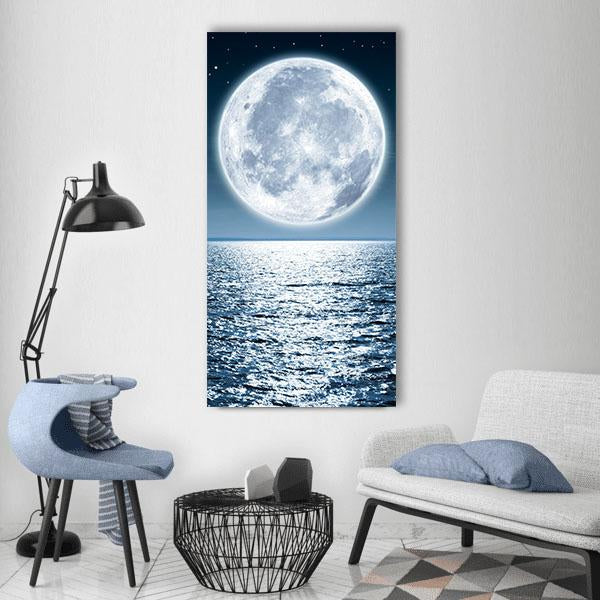 Moonlight Reflection on Ocean Vertical Canvas Wall Art in white, blue and navy, single vertical panel hung on a wall