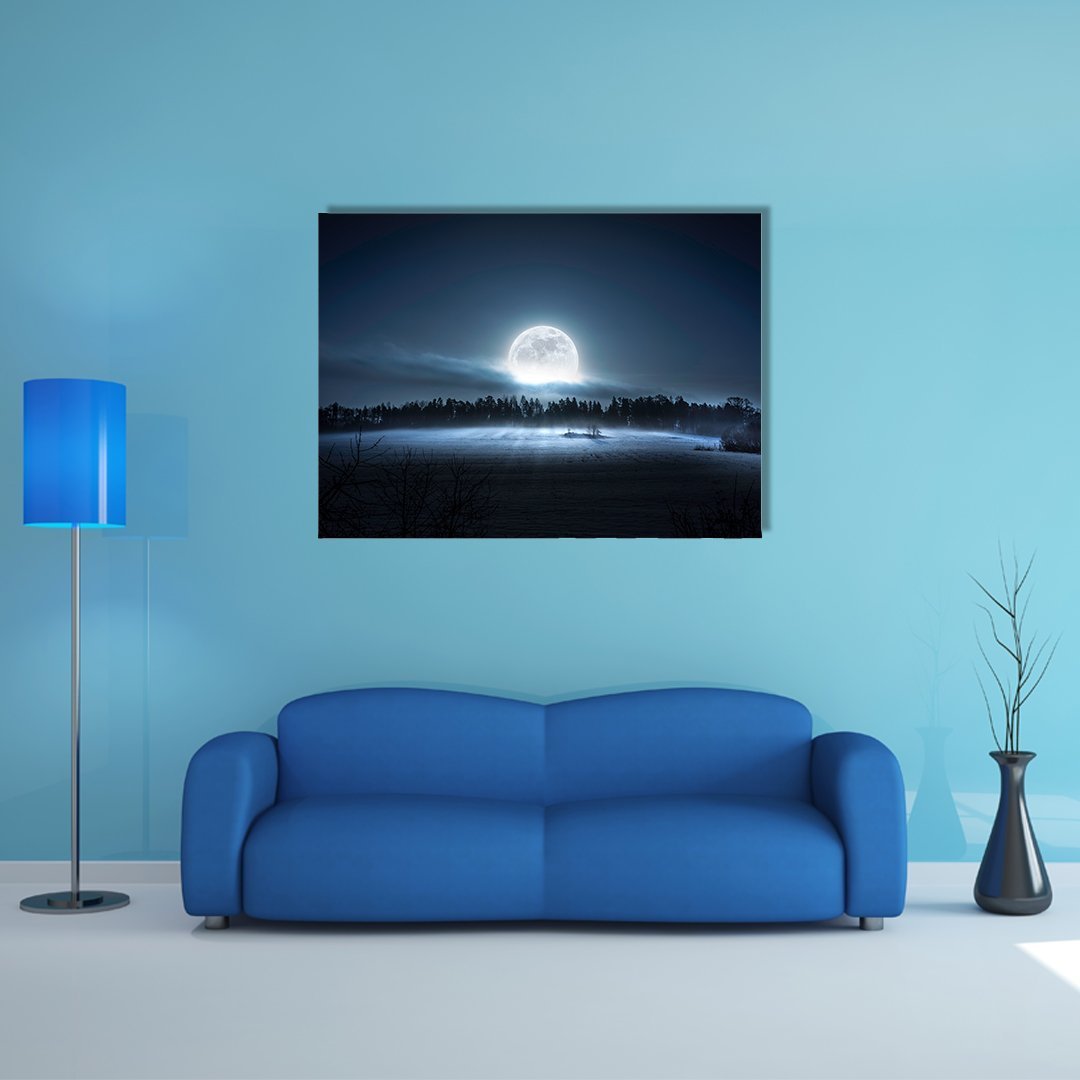 Moon Rising Over Forest Canvas Wall Art in black, white and blue, single panel hung on a wall