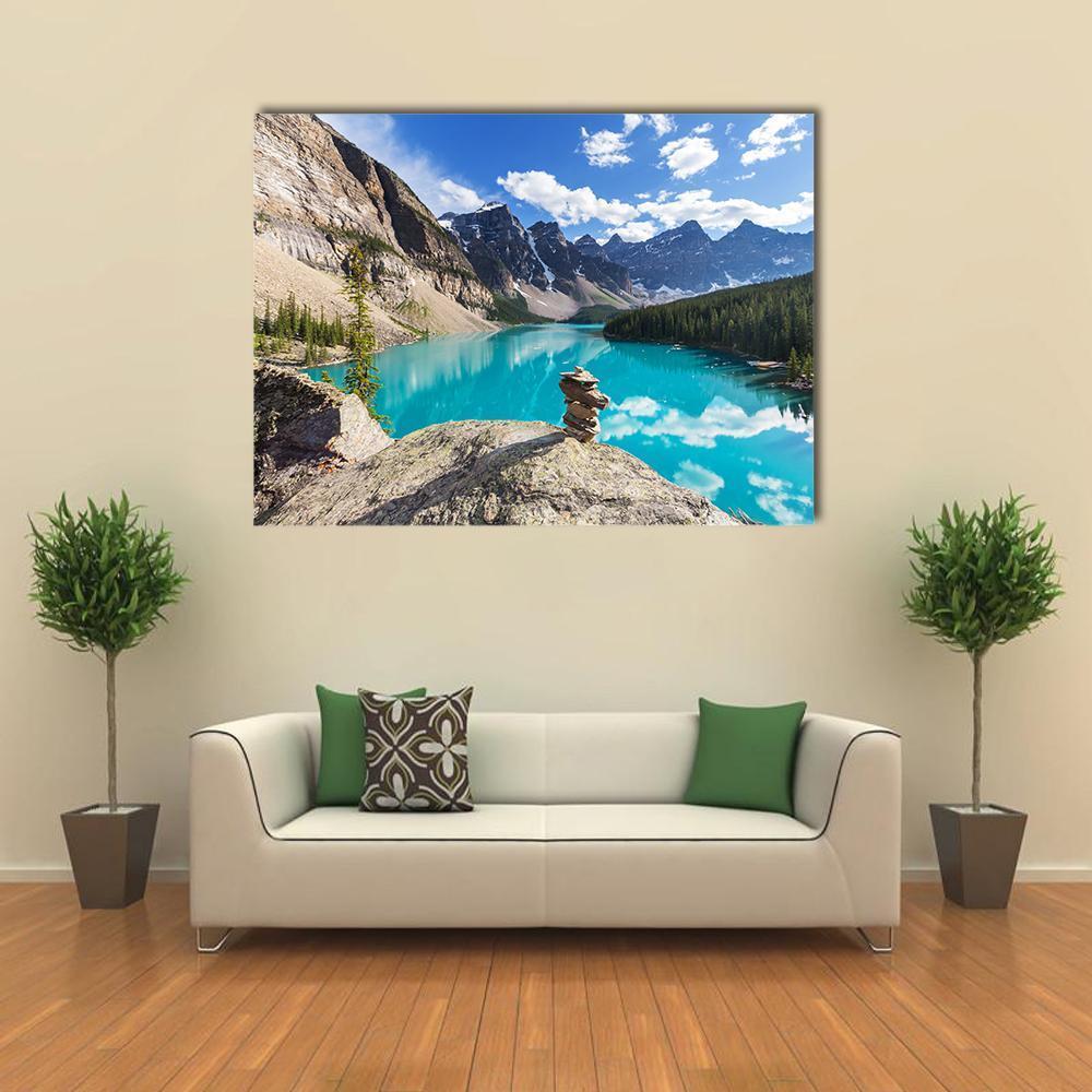 Moraine Lake Under Clouds Canvas Wall Art in gray, brown and blue, single panel hung on a wall