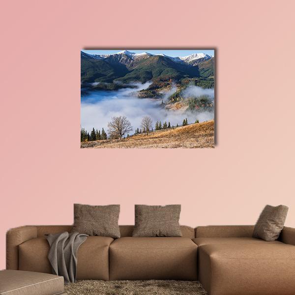 Foggy Mountain Village Canvas Wall Art in white, green and blue, single panel hung on a wall
