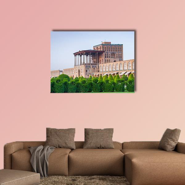 Aali Qapu Palace Facade and Garden Canvas Wall Art in brown, green and blue, single panel hung on a wall
